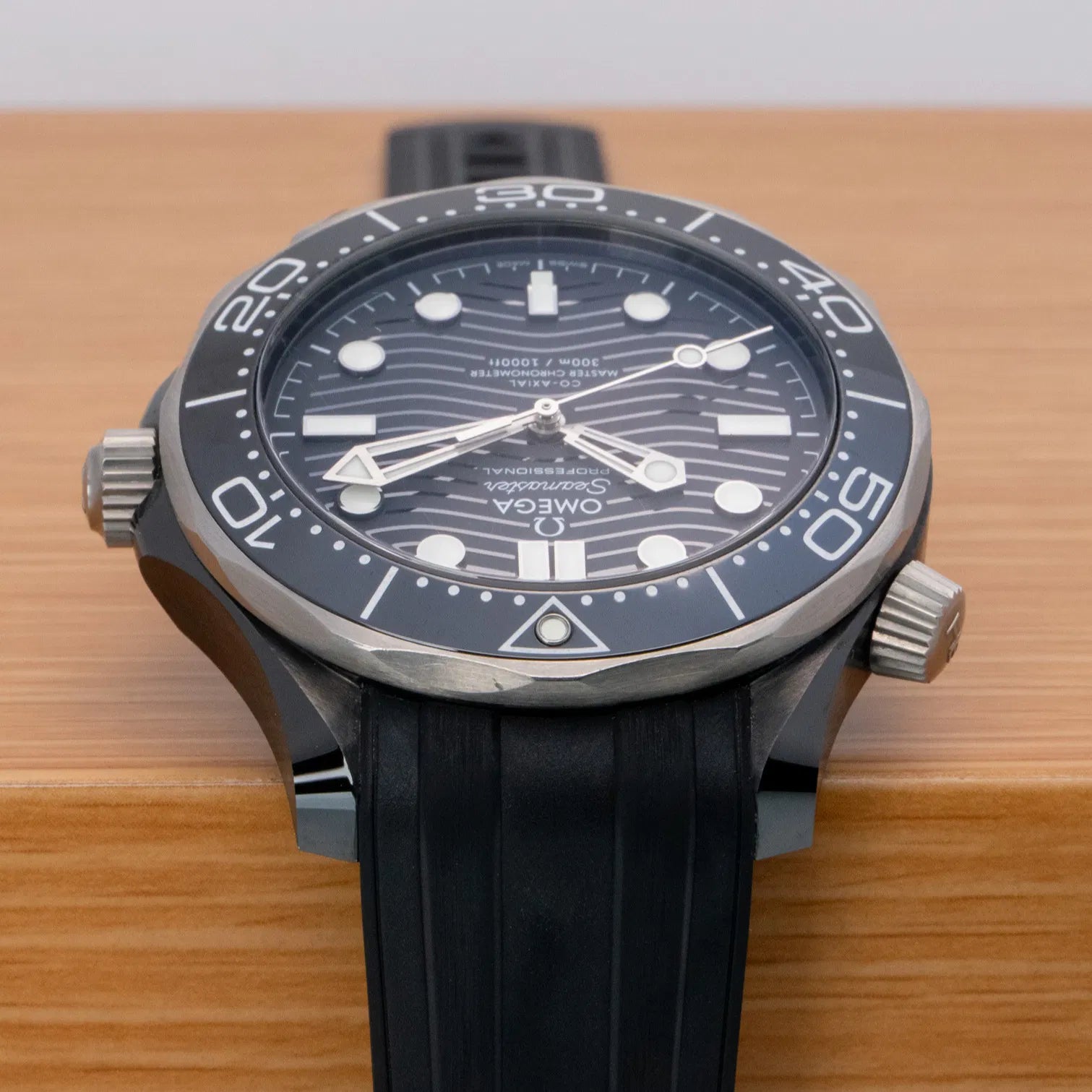 Omega Seamaster Diver 300M Co-Axial Master Chronometer with a black ceramic case and a matching black rubber strap