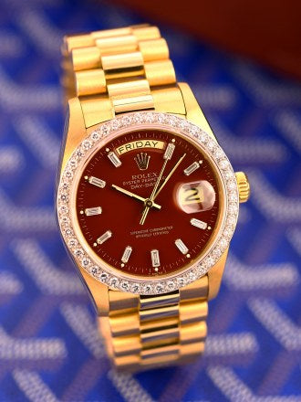 Rolex Day-Date features a distinct red vignette dial and a factory diamond-set bezel