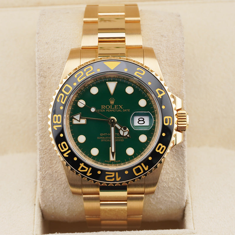 Rolex GMT-Master II Yellow Gold watch featuring a distinct green dial and a black ceramic bezel