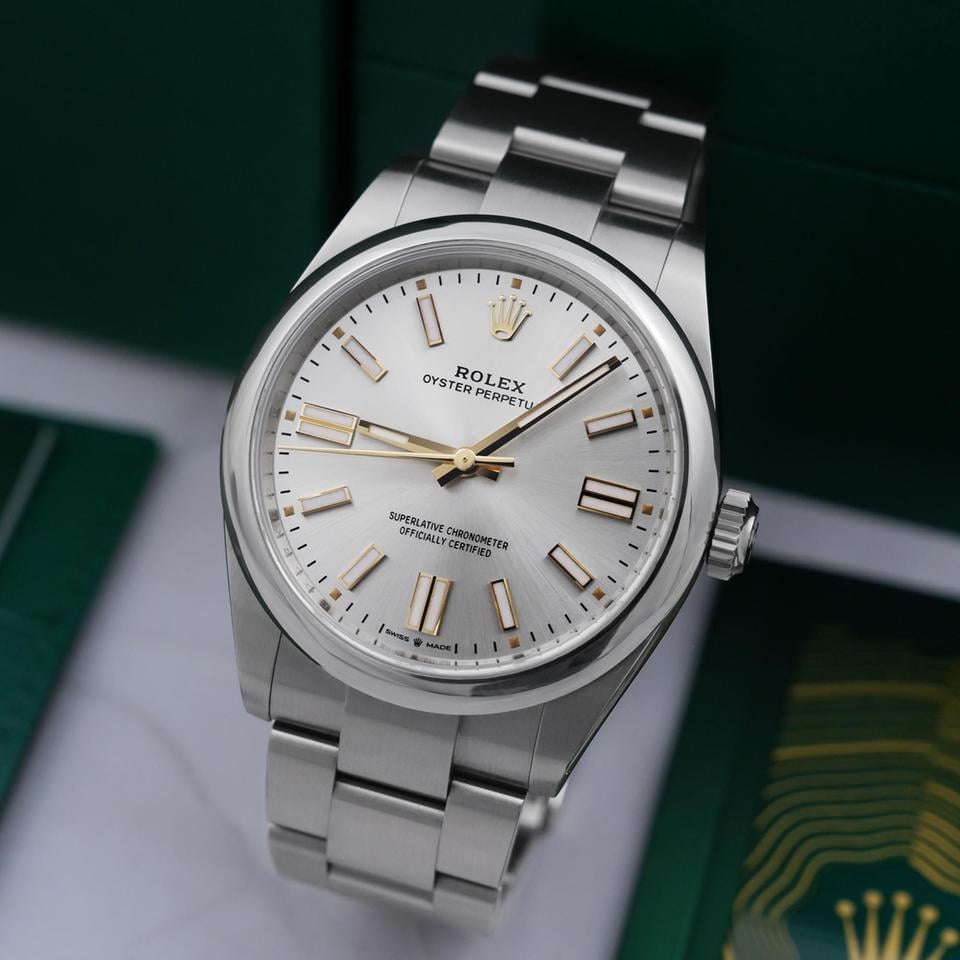Rolex Oyster Perpetual watch featuring a classic silver sunray finish dial