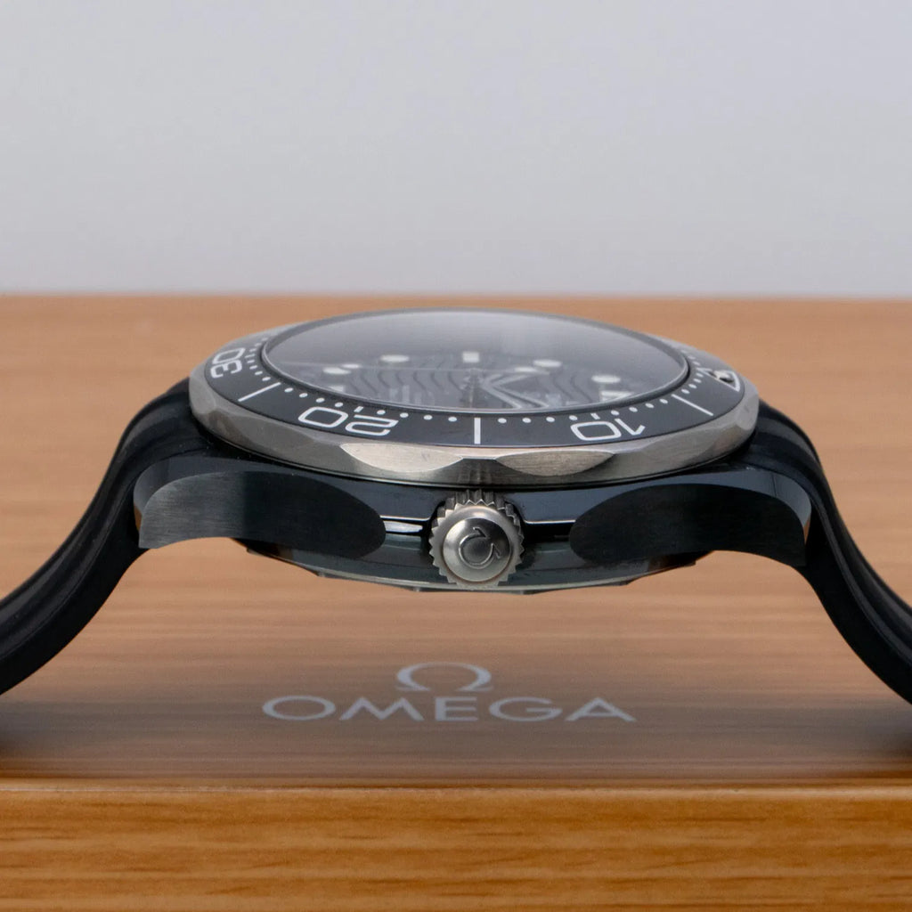Omega Seamaster Diver 300M Co-Axial Master Chronometer with a black ceramic case and a matching black rubber strap