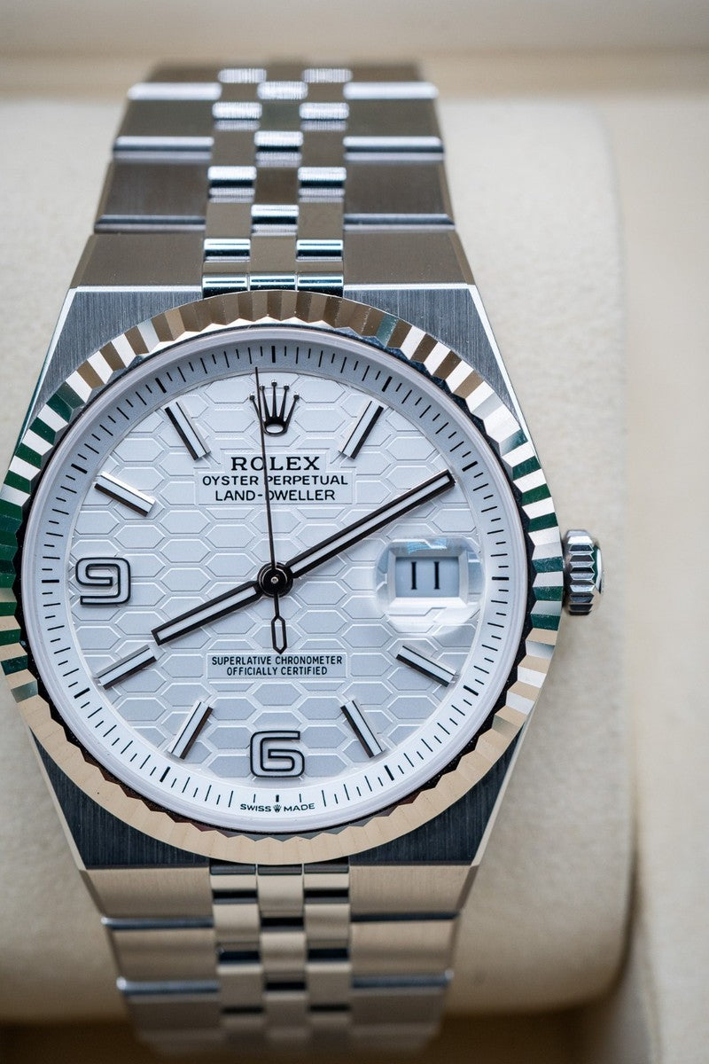 Rolex Land-Dweller features a distinctive white honeycomb motif dial and is paired with a stainless steel Jubilee bracelet