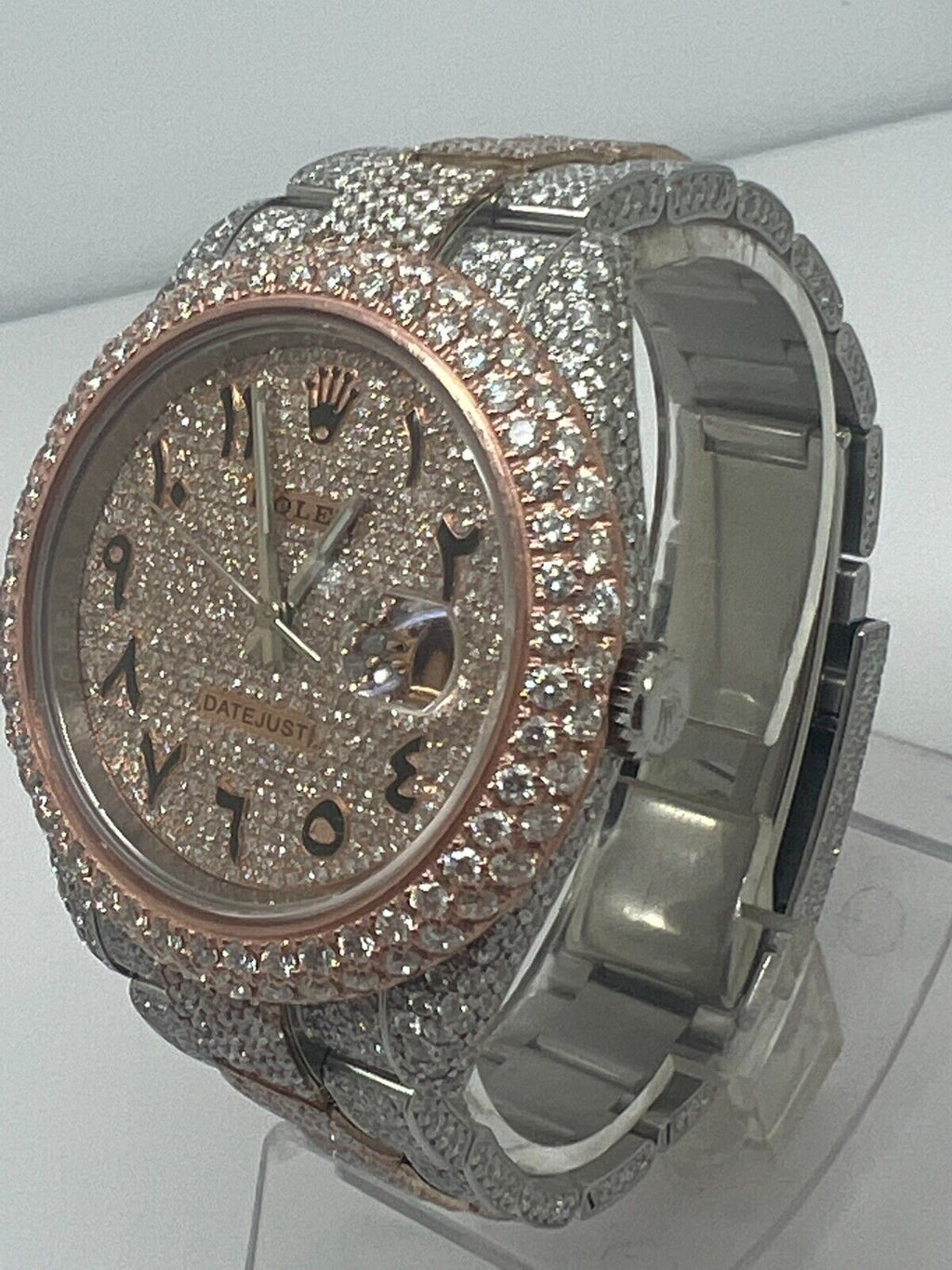 Rolex Datejust featuring a custom iced-out diamond dial with Arabic numerals and a full diamond-paved bezel and bracelet.