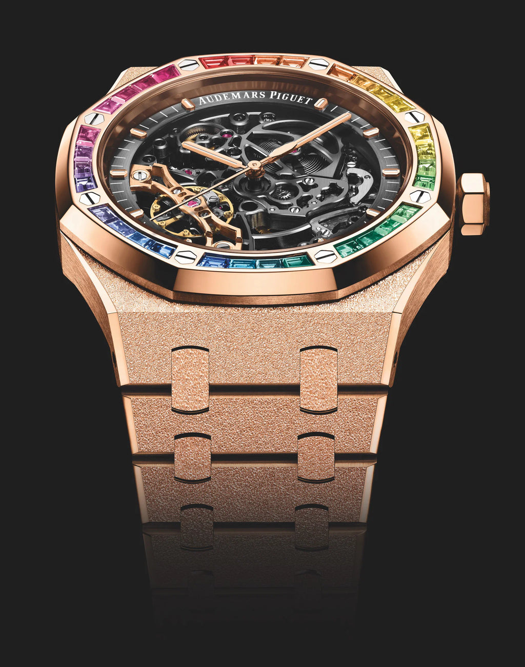 Audemars Piguet Royal Oak Double Balance Wheel Open-worked features a frosted rose gold finish and a bezel set with rainbow-colored baguette-cut sapphires