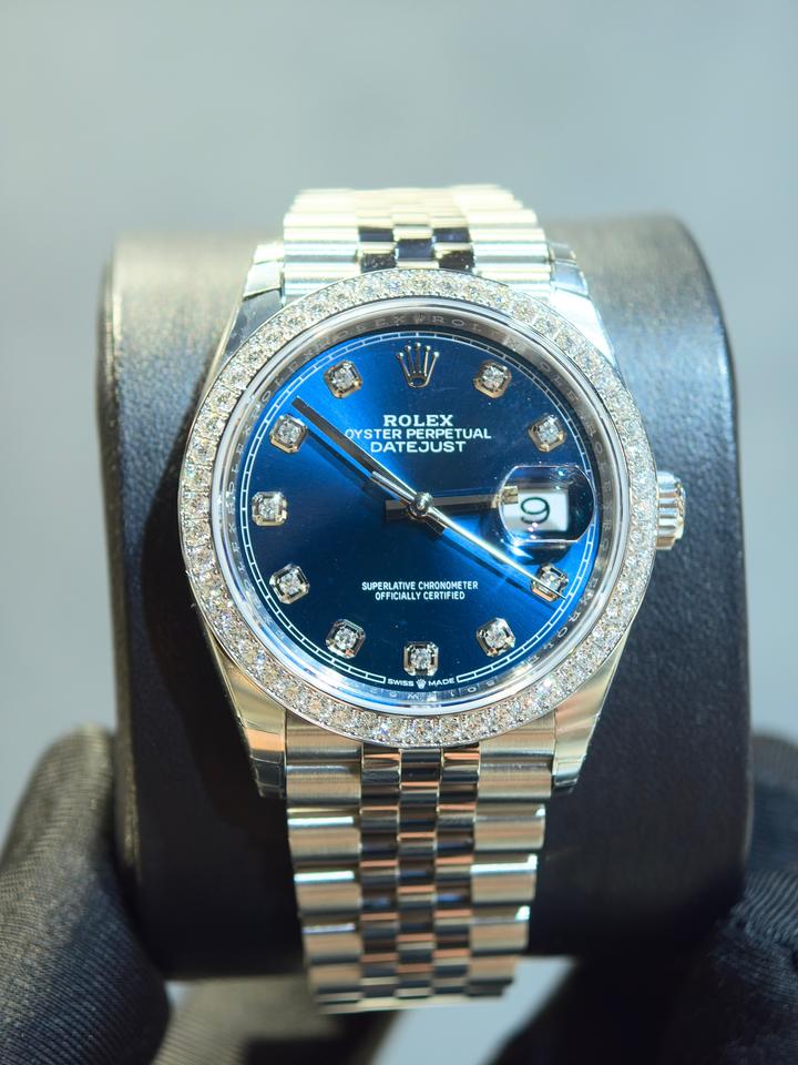 Rolex Datejust features a blue dial and a diamond bezel