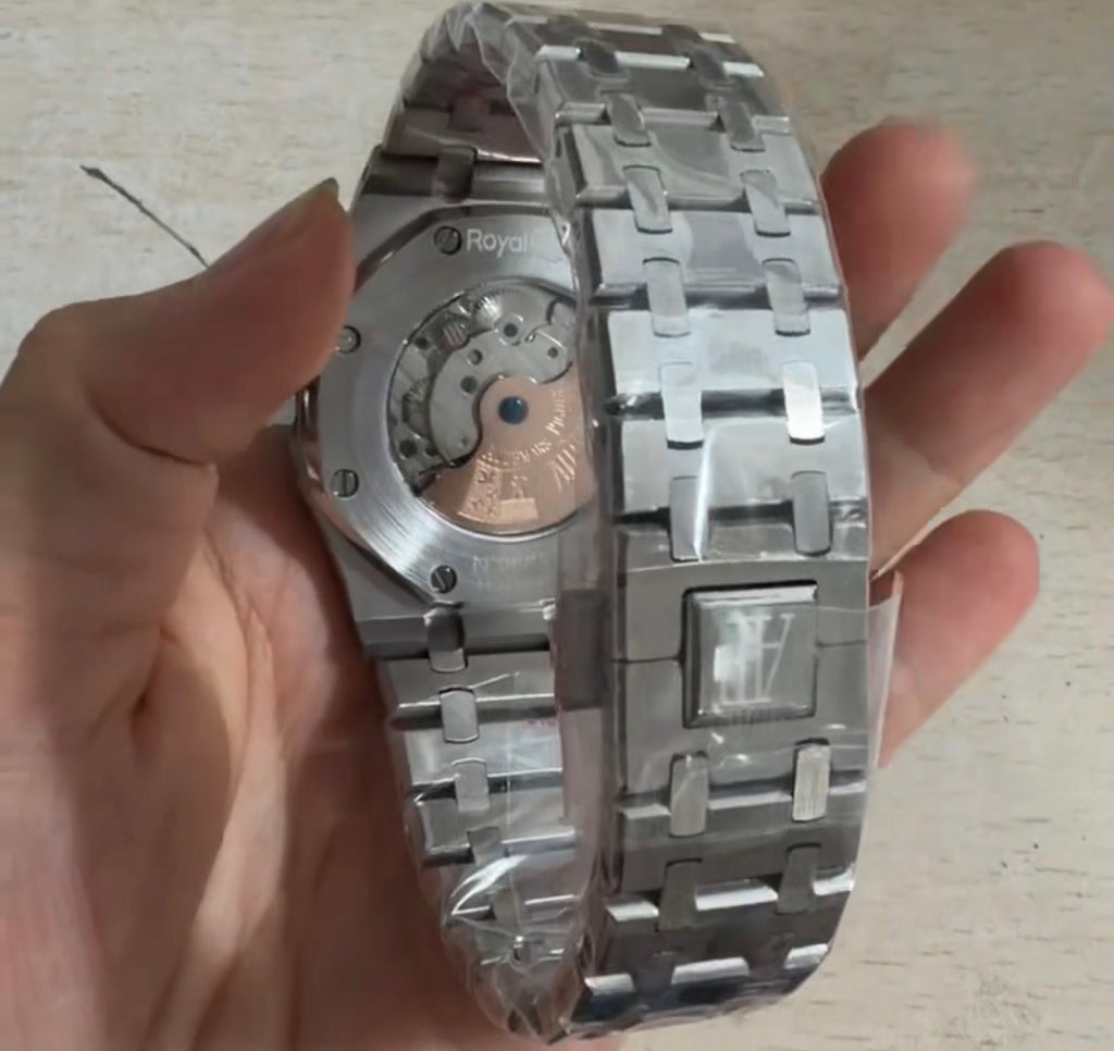Audemars Piguet Royal Oak Selfwinding Flying Tourbillon with a titanium case and a baguette-cut emerald bezel