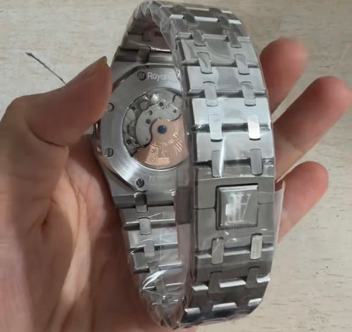 Audemars Piguet Royal Oak Selfwinding Flying Tourbillon with a titanium case and a baguette-cut emerald bezel
