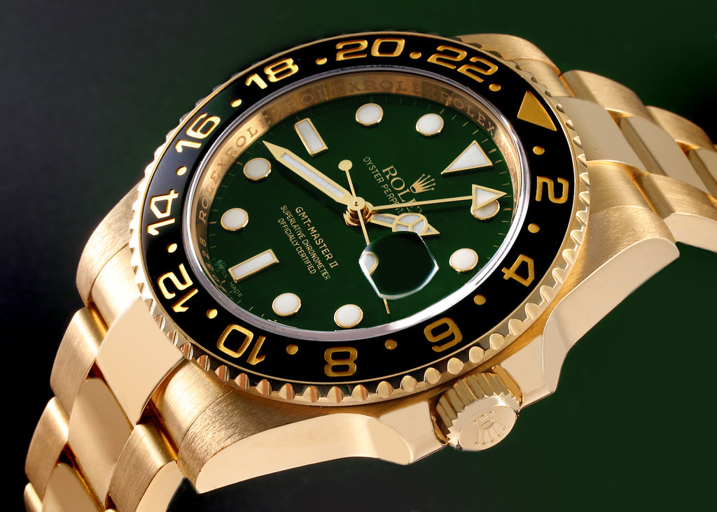 Rolex GMT-Master II Yellow Gold watch featuring a distinct green dial and a black ceramic bezel