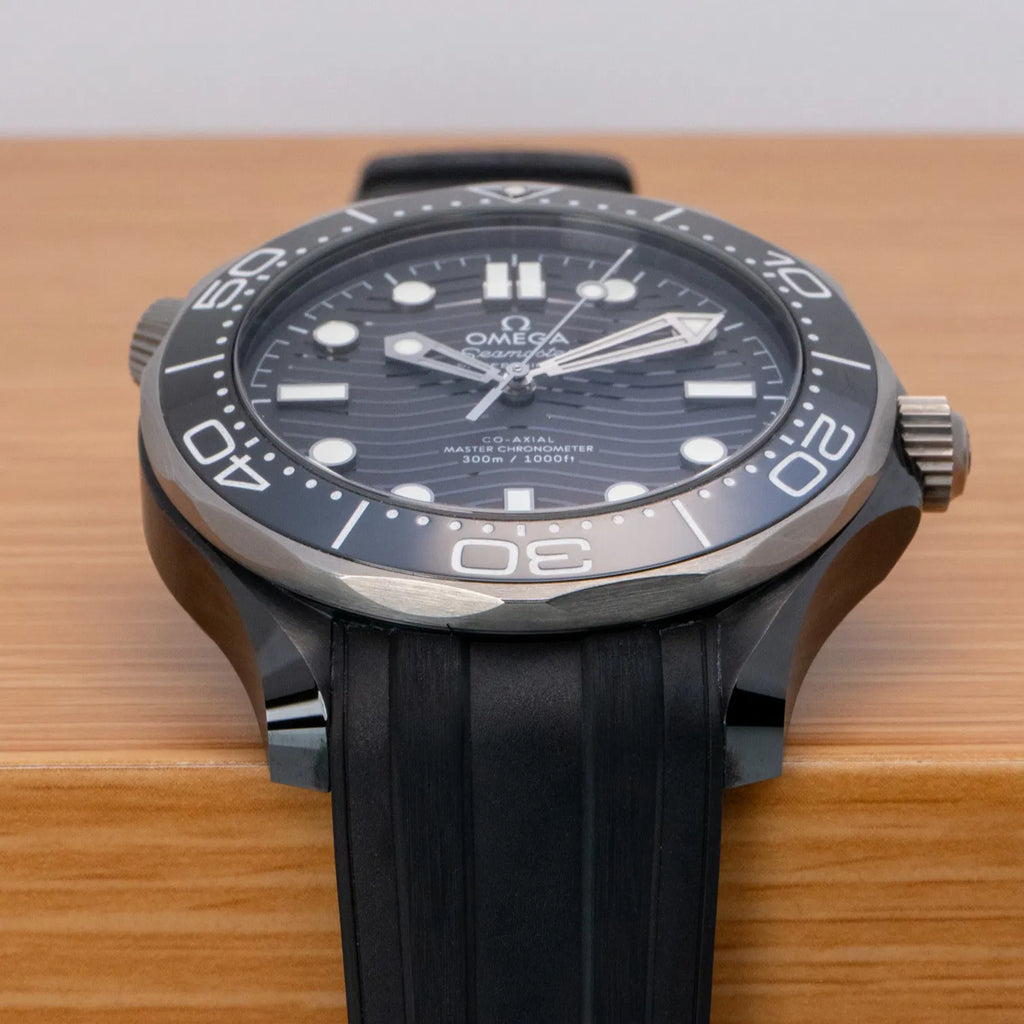 Omega Seamaster Diver 300M Co-Axial Master Chronometer with a black ceramic case and a matching black rubber strap