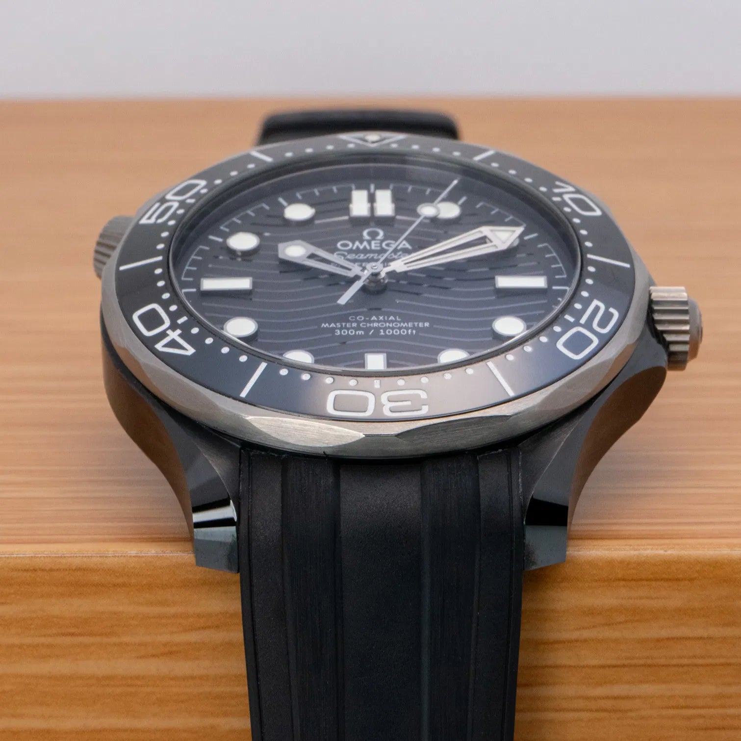 Omega Seamaster Diver 300M Co-Axial Master Chronometer with a black ceramic case and a matching black rubber strap