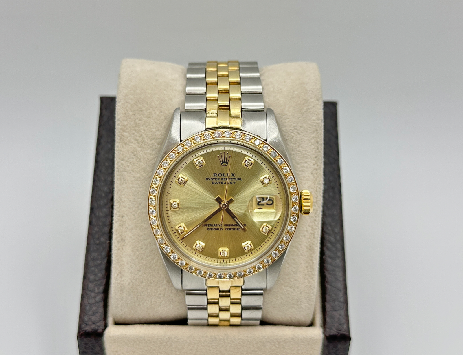 Rolex Datejust 16233 features a 36mm stainless steel case with an yellow gold bezel set with diamonds and a champagne diamond dial