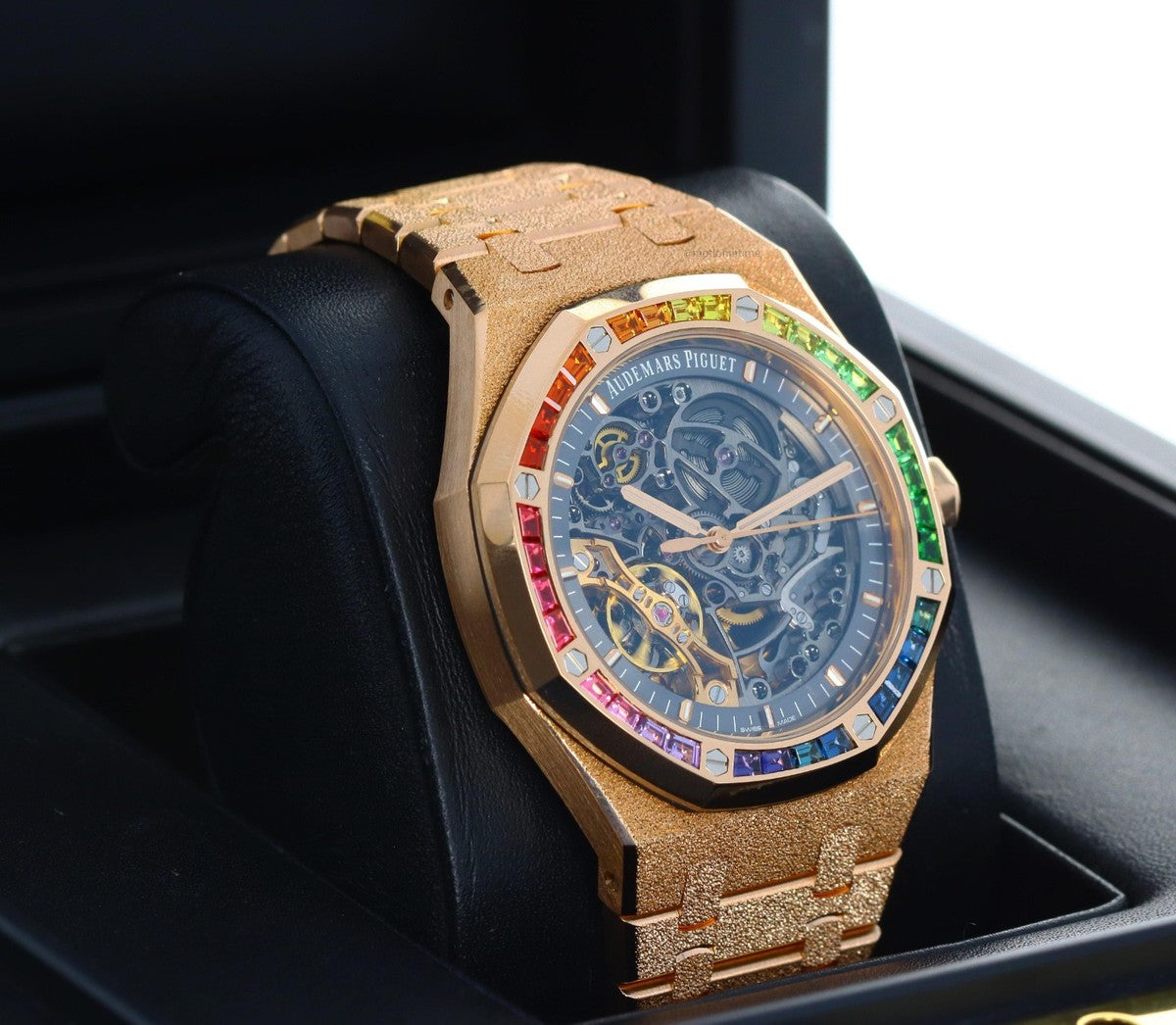 Audemars Piguet Royal Oak Double Balance Wheel Open-worked features a frosted rose gold finish and a bezel set with rainbow-colored baguette-cut sapphires