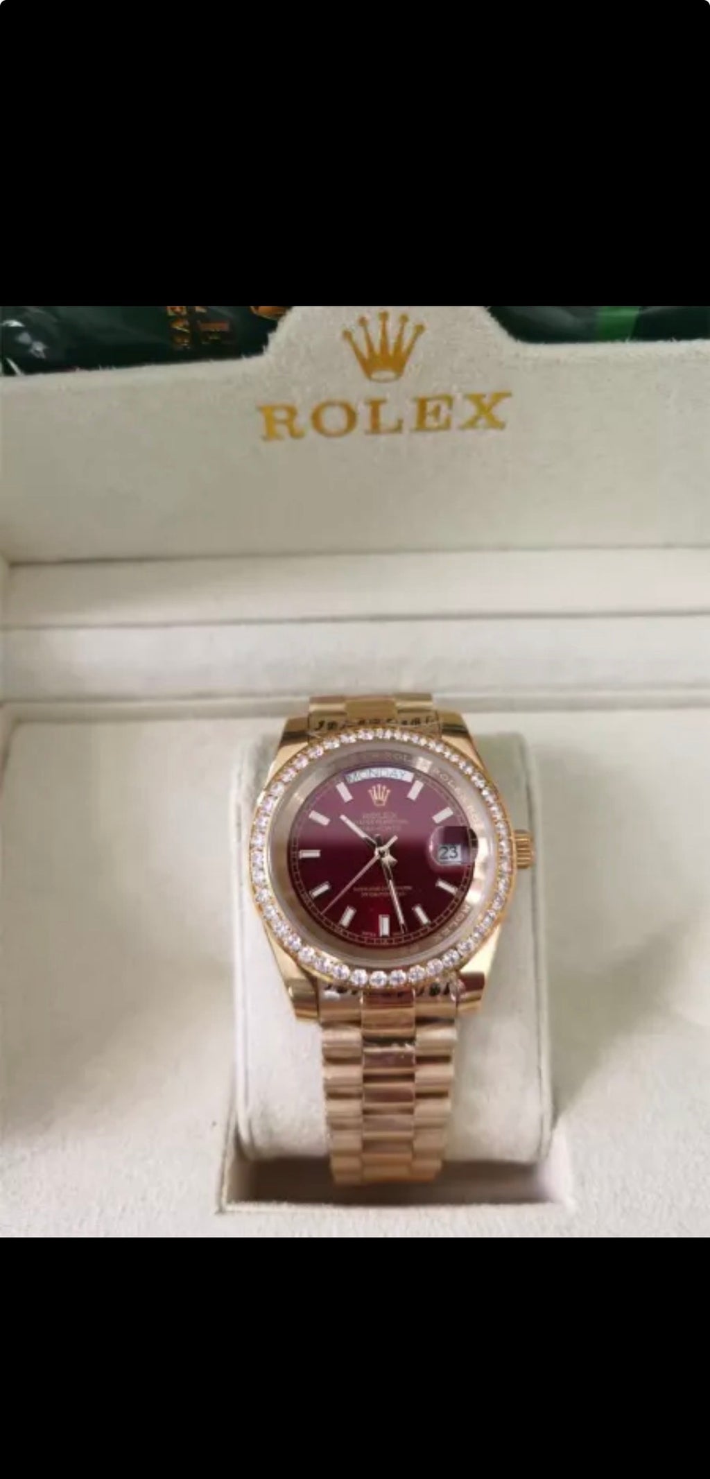 Rolex Day-Date features a distinct red vignette dial and a factory diamond-set bezel
