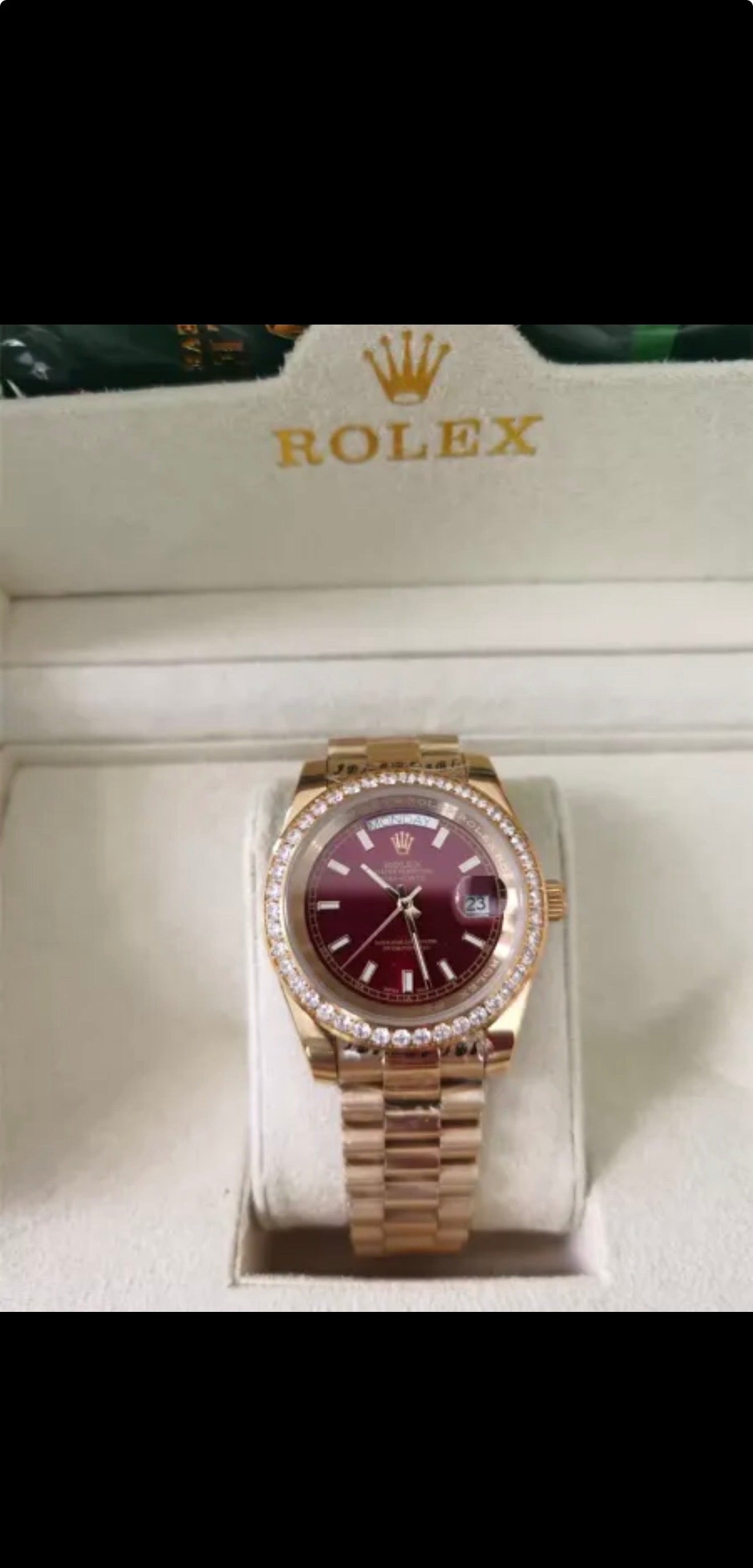 Rolex Day-Date features a distinct red vignette dial and a factory diamond-set bezel