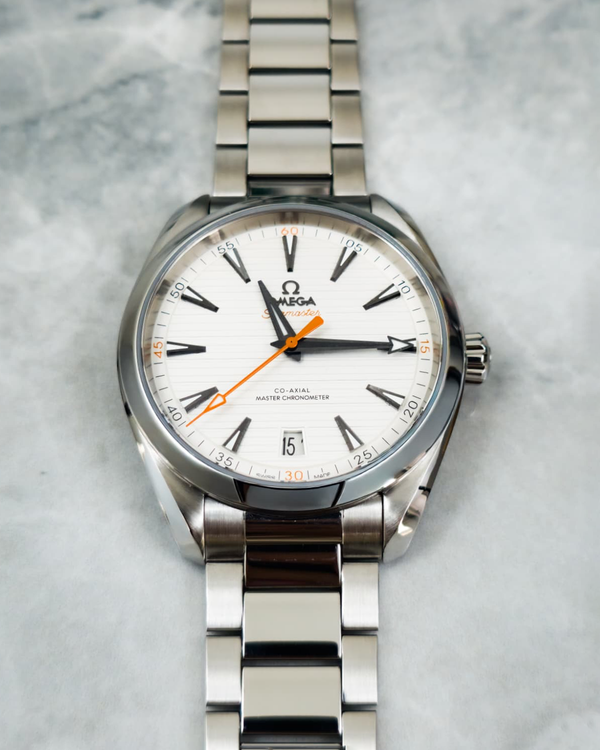 Omega Seamaster Aqua Terra 150M with a white horizontal teak-patterned dial and prominent orange accents
