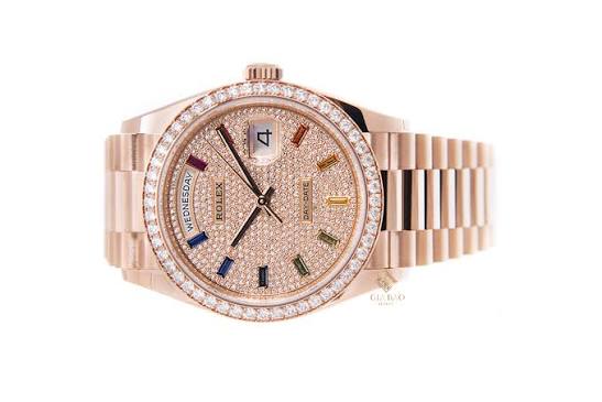 Rolex Day-Date 36mm in Everose gold features a diamond-paved dial with 10 rainbow-colored baguette-cut sapphire hour markers