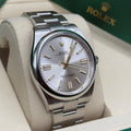 Rolex Oyster Perpetual watch featuring a classic silver sunray finish dial