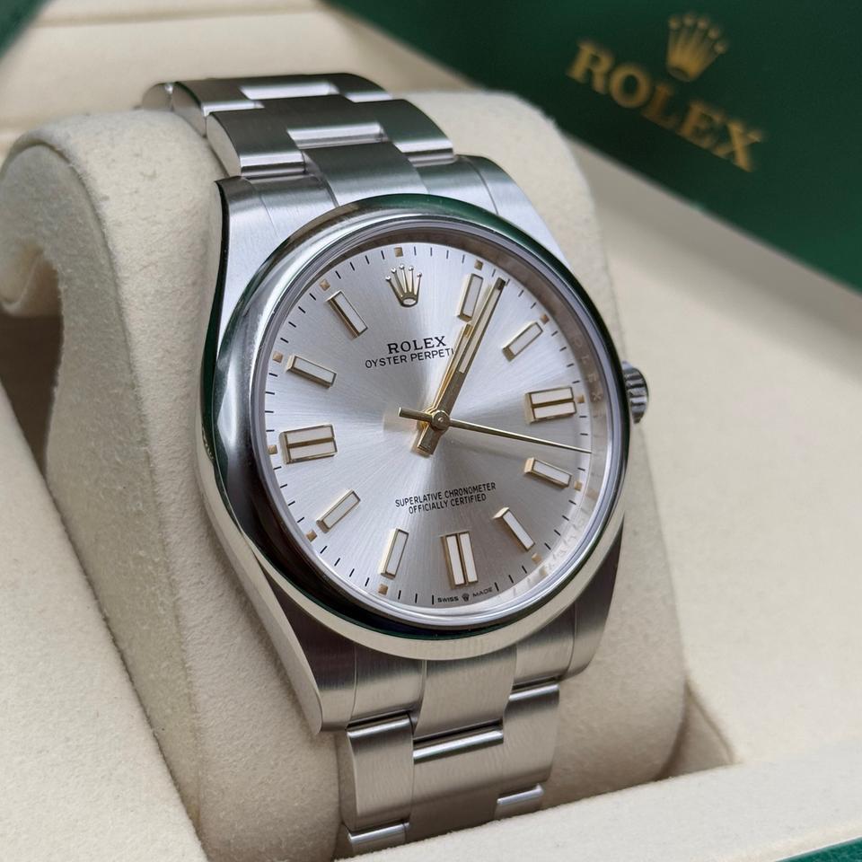 Rolex Oyster Perpetual watch featuring a classic silver sunray finish dial