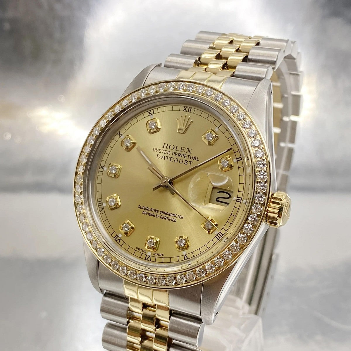 Rolex Datejust 16233 features a 36mm stainless steel case with an yellow gold bezel set with diamonds and a champagne diamond dial