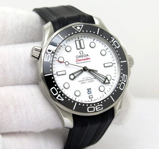 Omega Seamaster Diver 300M features a striking white ceramic dial with a distinctive wave pattern and a durable black rubber strap