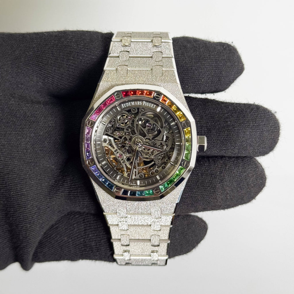 Audemars Piguet Royal Oak Double Balance Wheel Open-worked features a frosted white gold finish and a bezel set with rainbow-colored baguette-cut sapphires