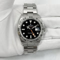 Rolex Explorer II, featuring a black dial, fixed steel bezel, and a distinctive orange GMT hand