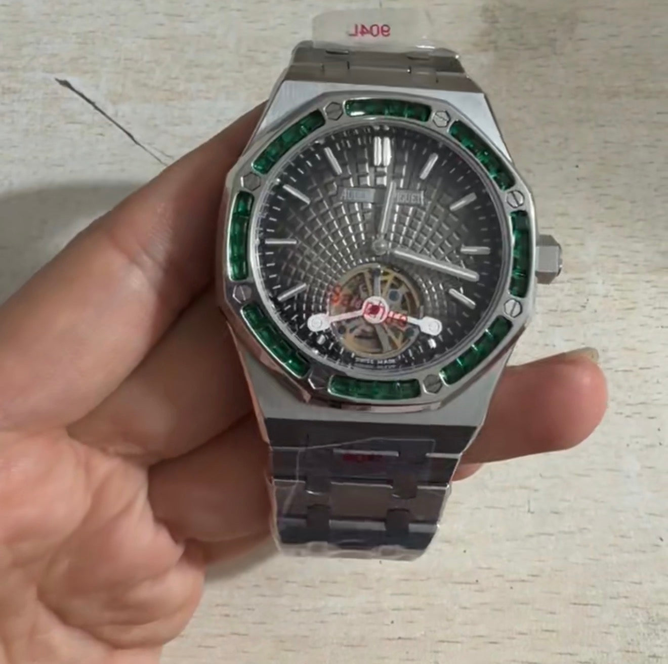 Audemars Piguet Royal Oak Selfwinding Flying Tourbillon with a titanium case and a baguette-cut emerald bezel