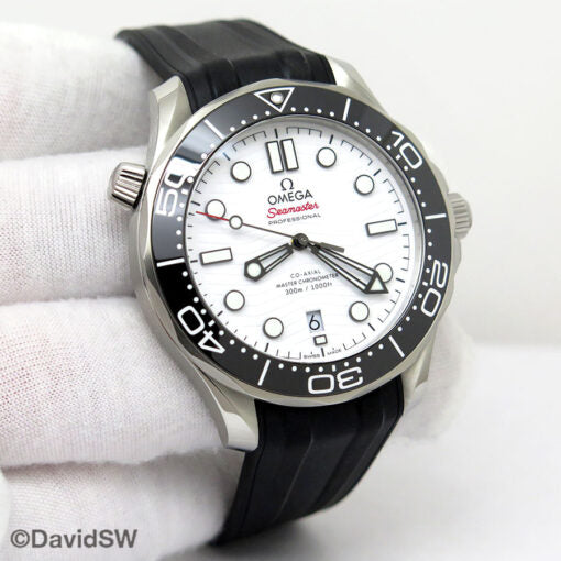 Omega Seamaster Diver 300M features a striking white ceramic dial with a distinctive wave pattern and a durable black rubber strap