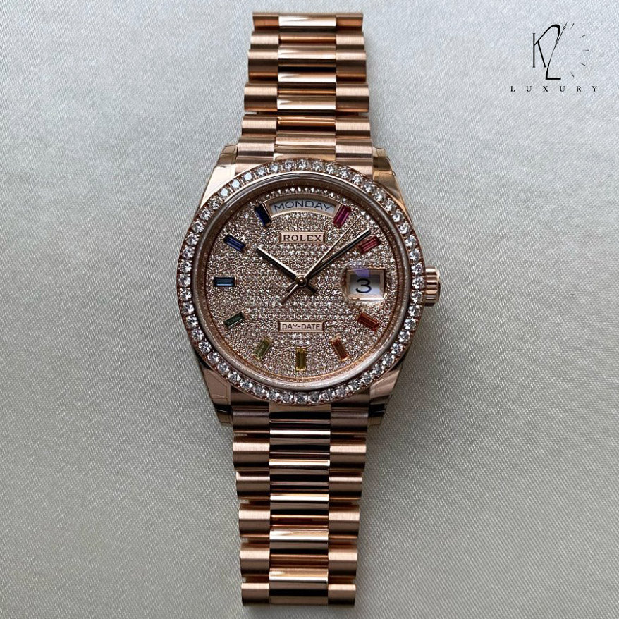 Rolex Day-Date 36mm in Everose gold features a diamond-paved dial with 10 rainbow-colored baguette-cut sapphire hour markers