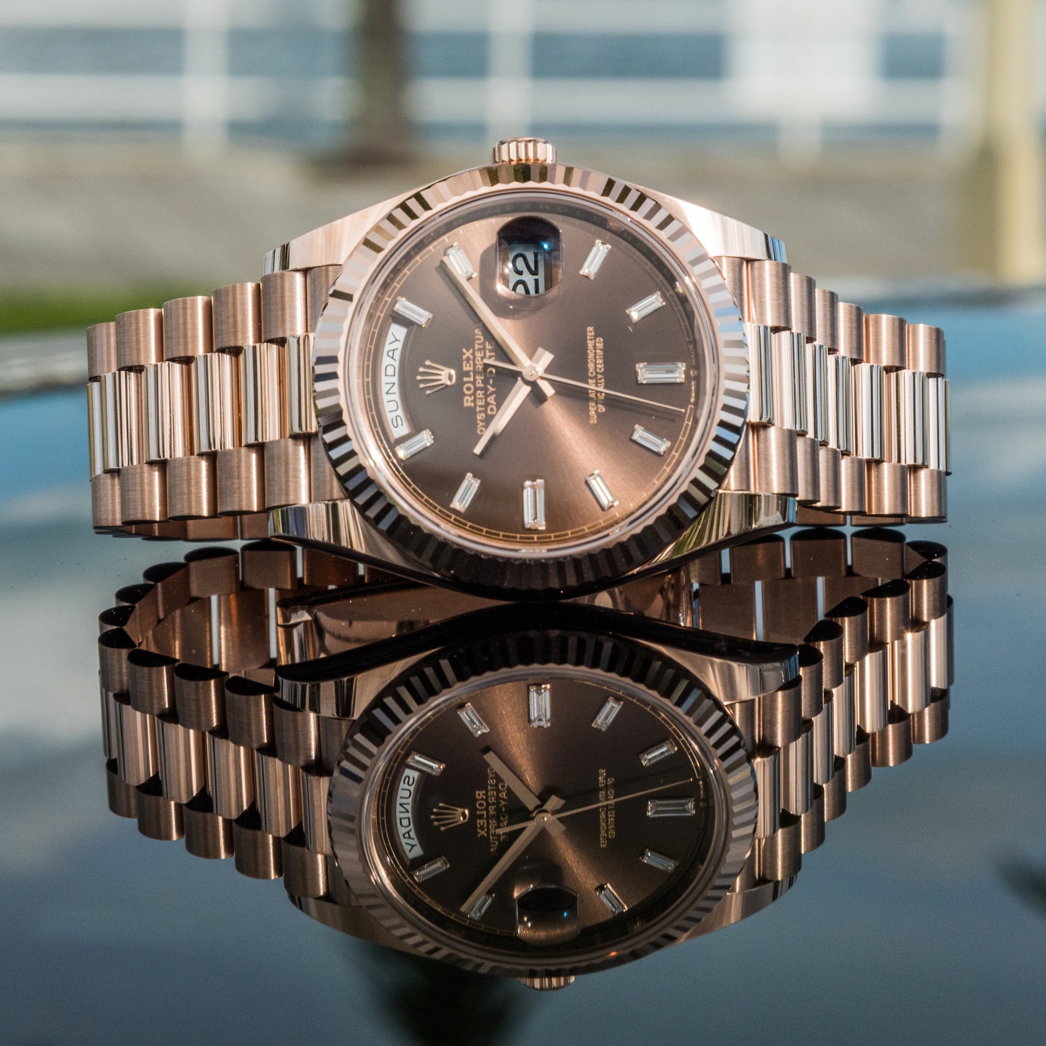 Rolex Day-Date crafted in Everose gold with a distinct chocolate sunray dial
