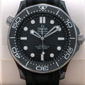 Omega Seamaster Diver 300M Co-Axial Master Chronometer with a black ceramic case and a matching black rubber strap