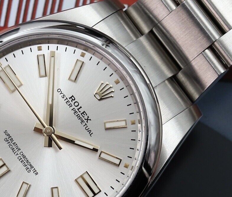Rolex Oyster Perpetual watch featuring a classic silver sunray finish dial