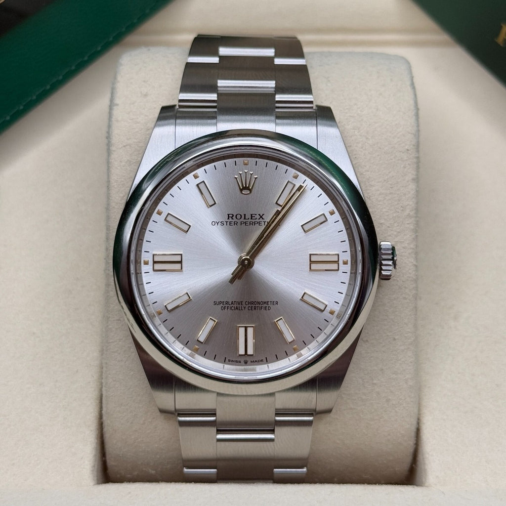 Rolex Oyster Perpetual watch featuring a classic silver sunray finish dial