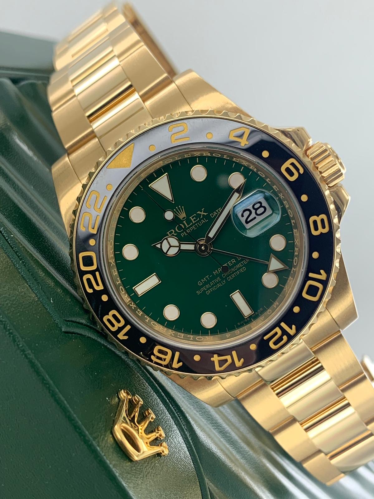 Rolex GMT-Master II Yellow Gold watch featuring a distinct green dial and a black ceramic bezel