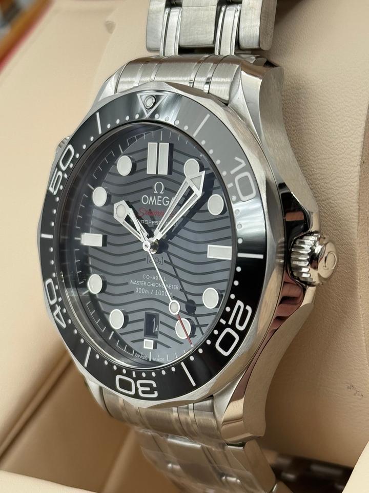 Omega Seamaster Diver 300M, distinguished by its black ceramic wave-patterned dial and stainless steel bracelet