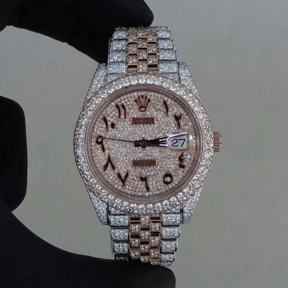 Rolex Datejust featuring a custom iced-out diamond dial with Arabic numerals and a full diamond-paved bezel and bracelet.
